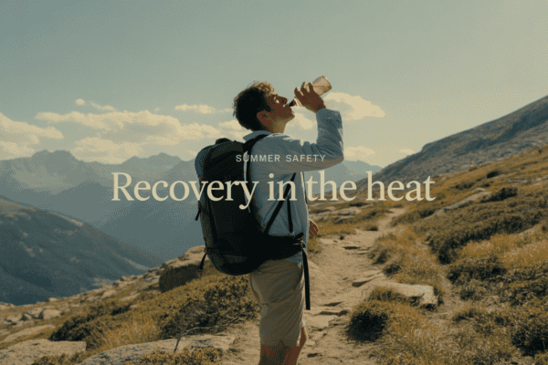 Person drinking water during mountain hike for detox and recovery.