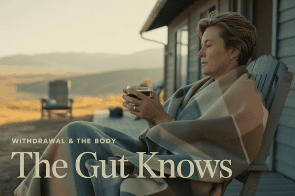 Woman relaxing outdoors with a drink, promoting gut health and detox programs.